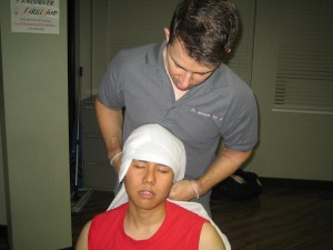 Applying gauze to control a bleeding head injury